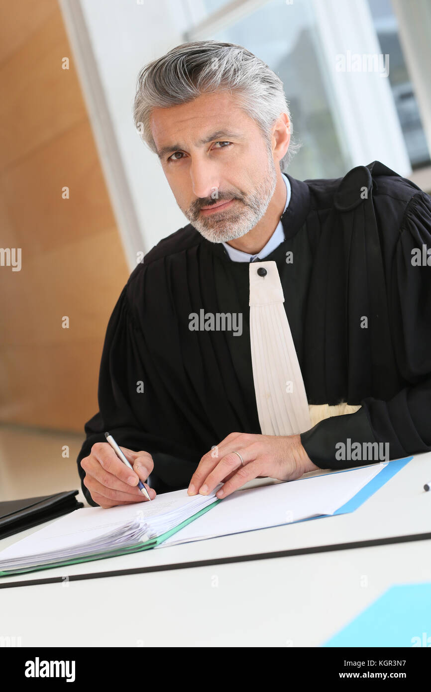 Mature lawyer working on judgement report Stock Photo
