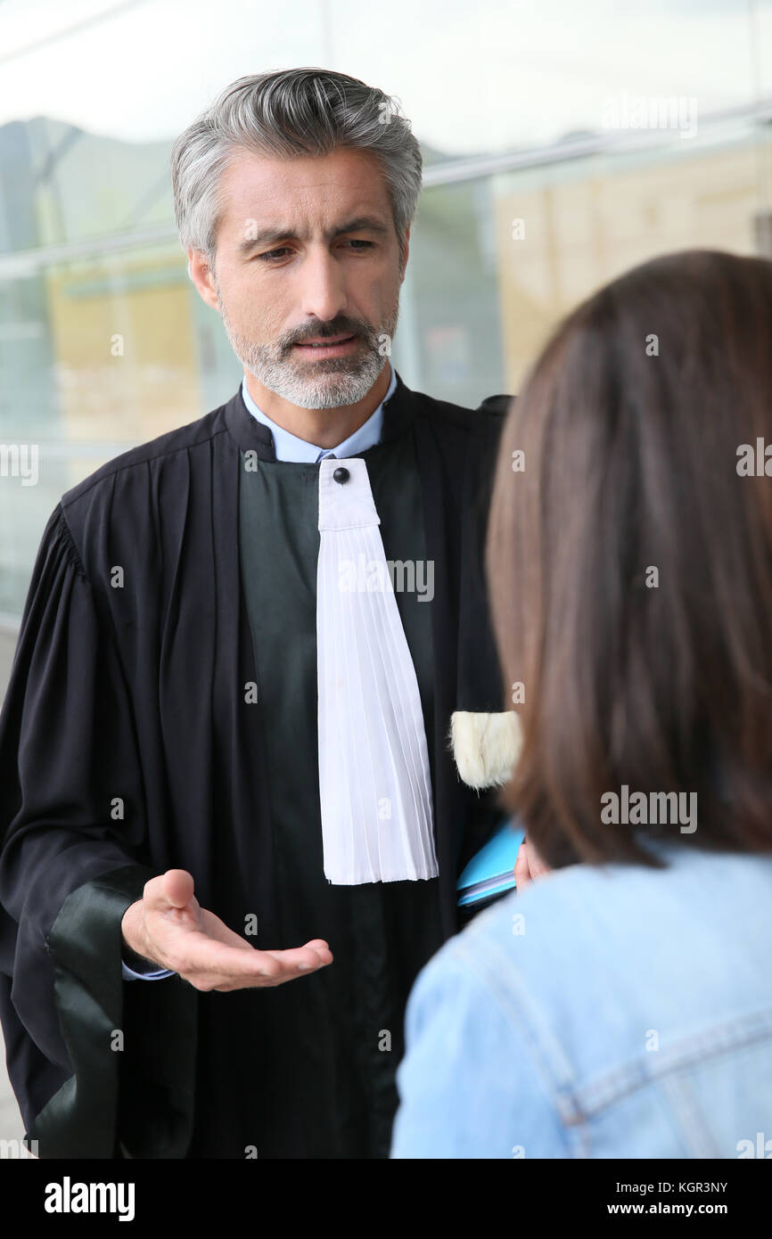 Lawyer meeting client in courthouse before trial Stock Photo