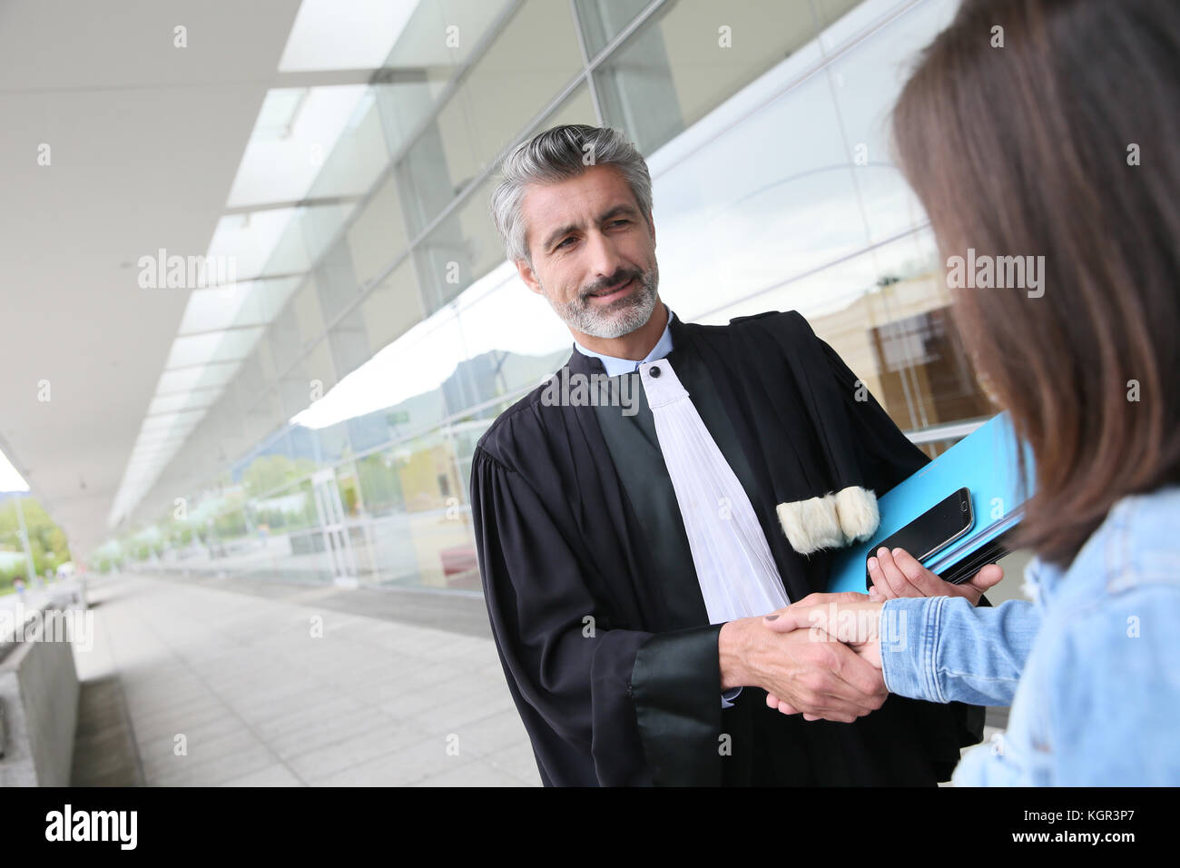 Lawyer meeting client in courthouse before trial Stock Photo Alamy