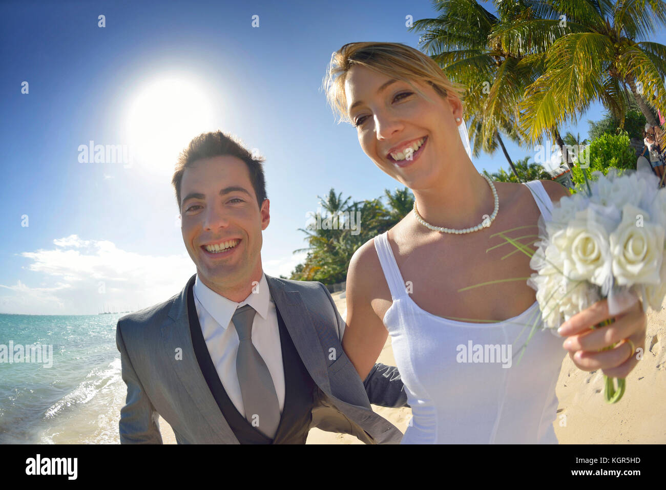 Just married couple walking on the beach Stock Photo - Alamy