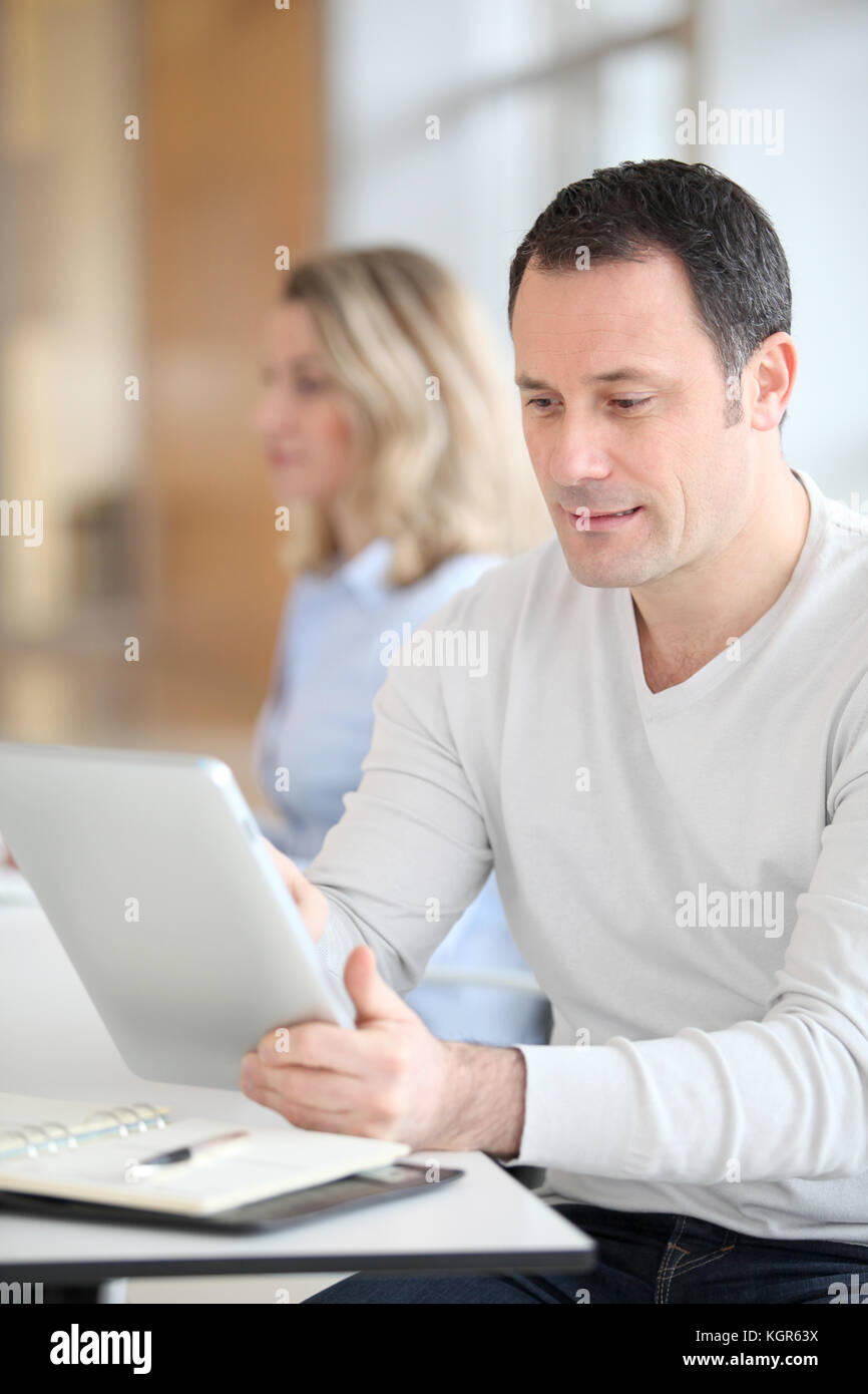 Office worker in the office using electronic tab Stock Photo Alamy