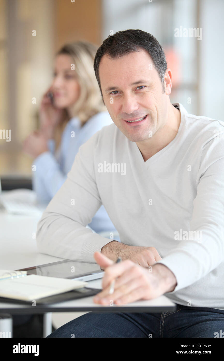 Office worker in the office using electronic tab Stock Photo - Alamy
