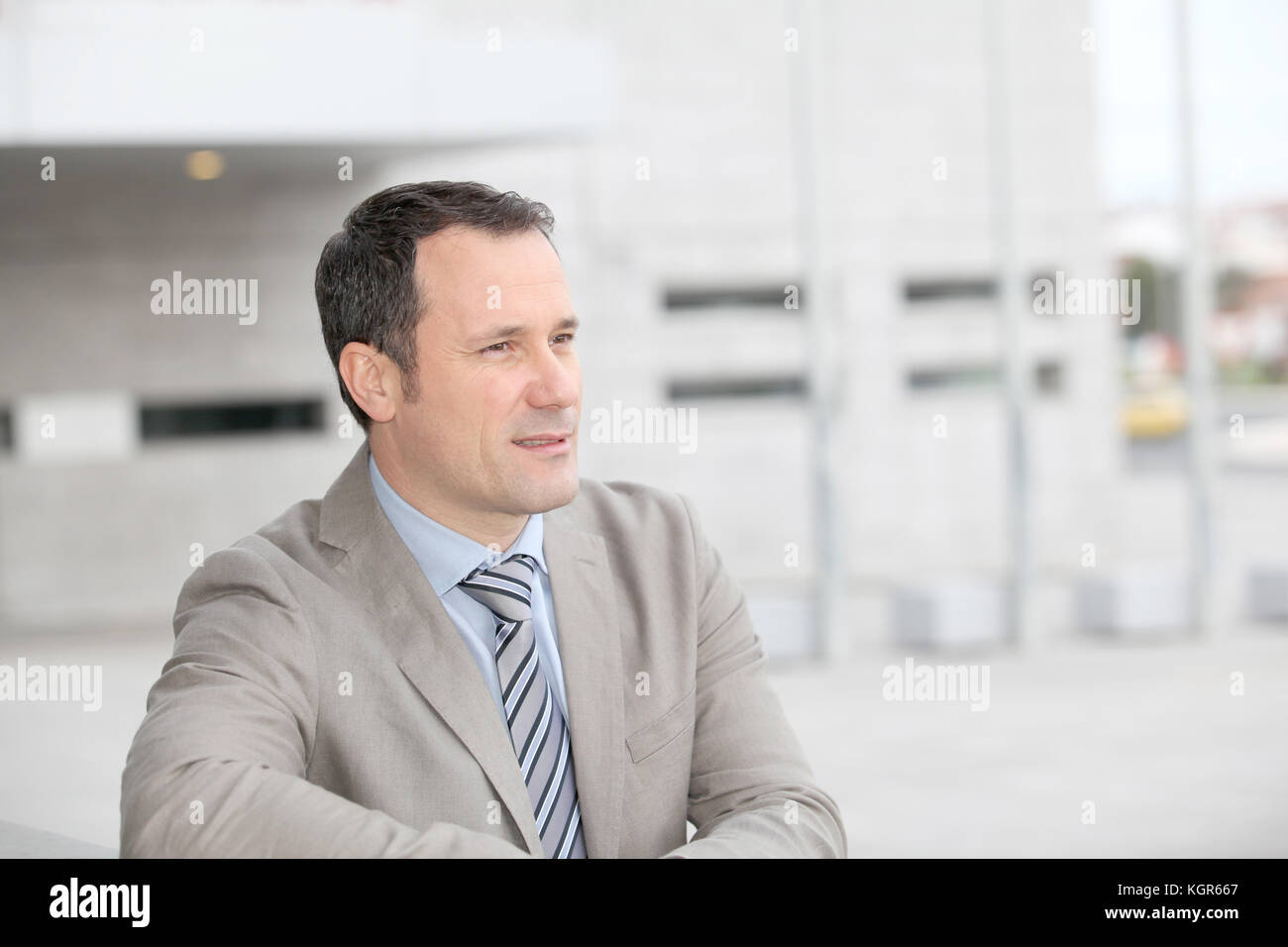Businessman standing outside the office Stock Photo - Alamy