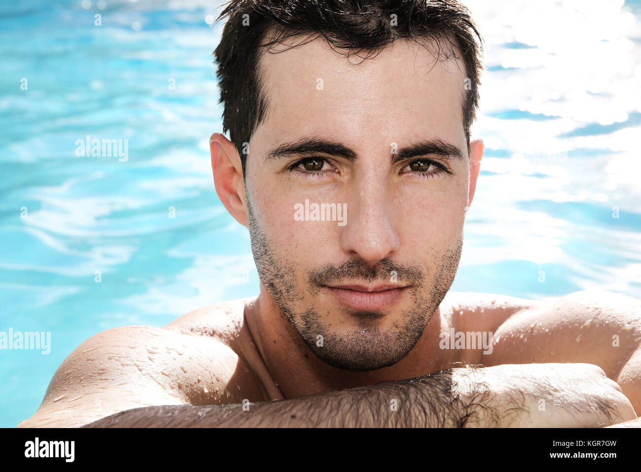 Good looking man in swimming pool hires stock photography and images