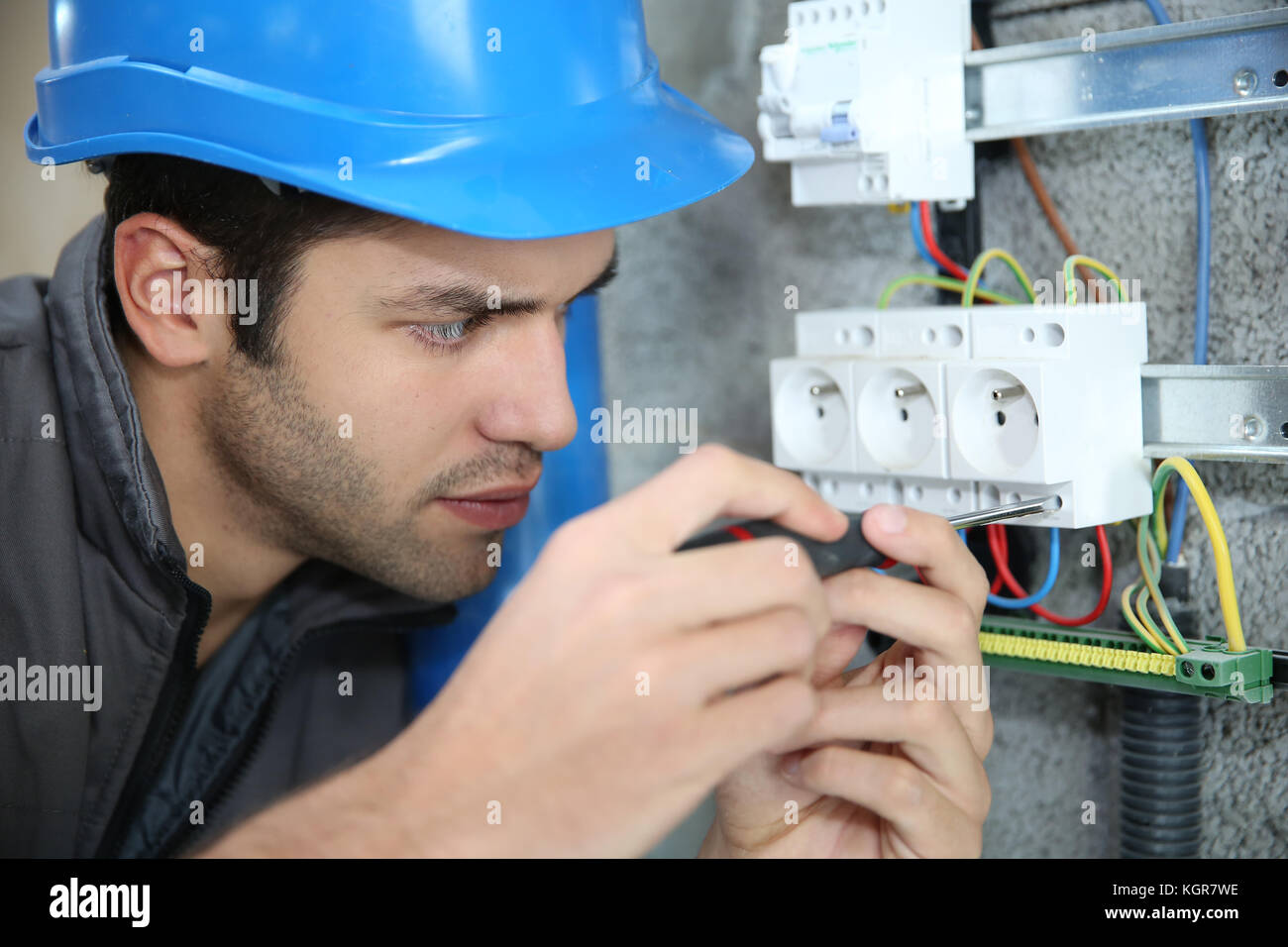 Young electrician working on building site Stock Photo Alamy