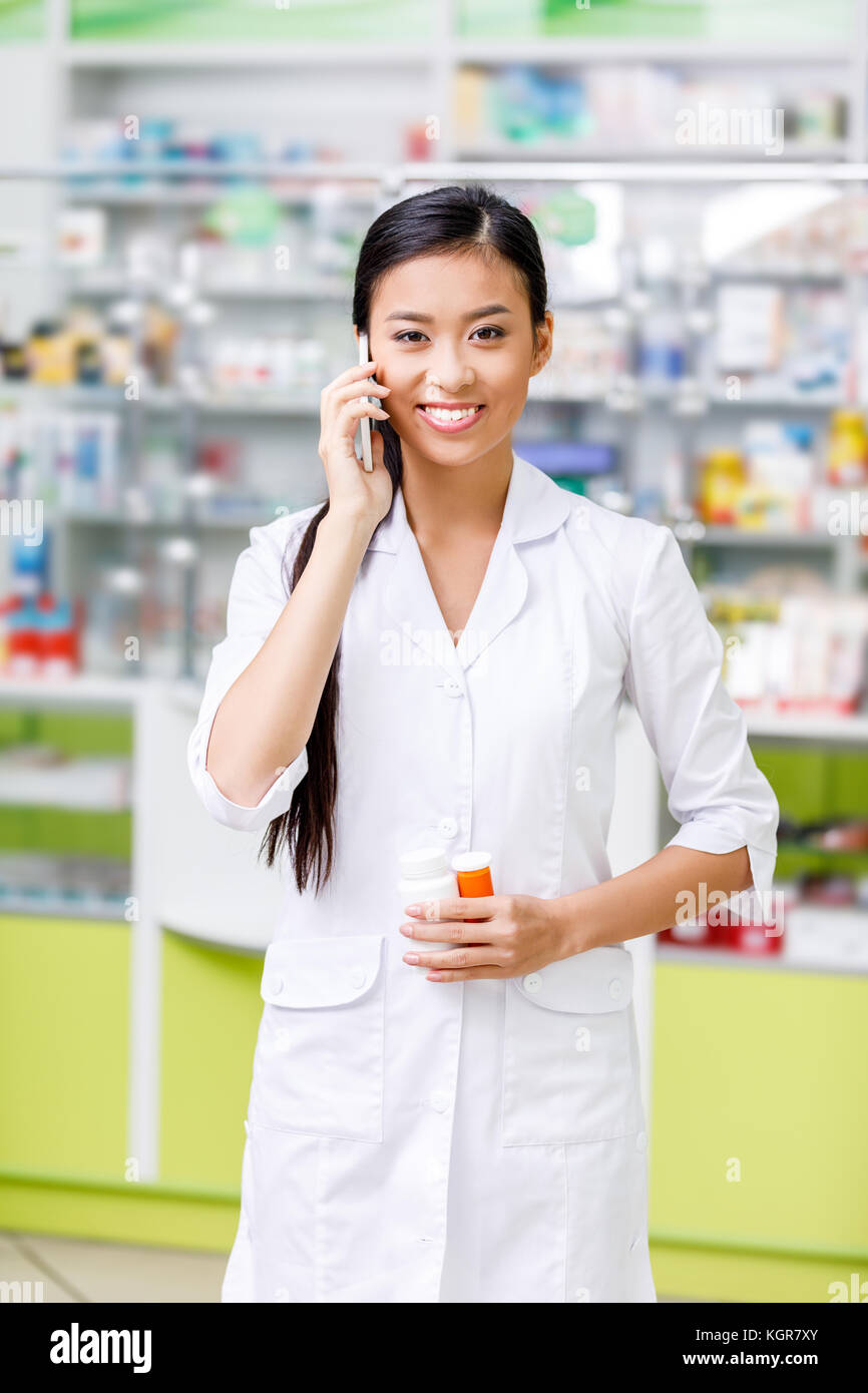 Asian female pharmacist talking hi-res stock photography and images - Alamy