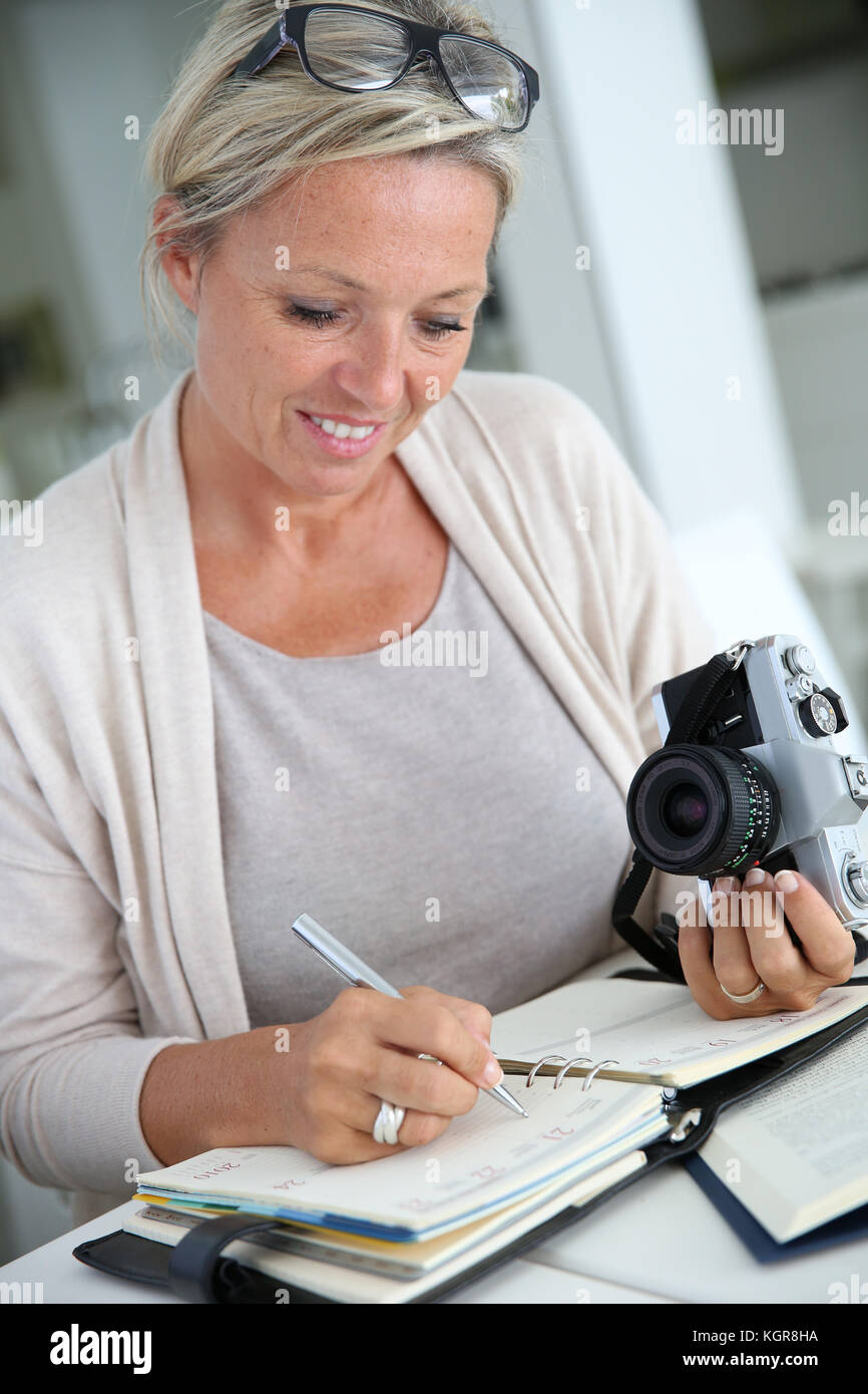 Beautiful mature woman reporter working on project Stock Photo - Alamy