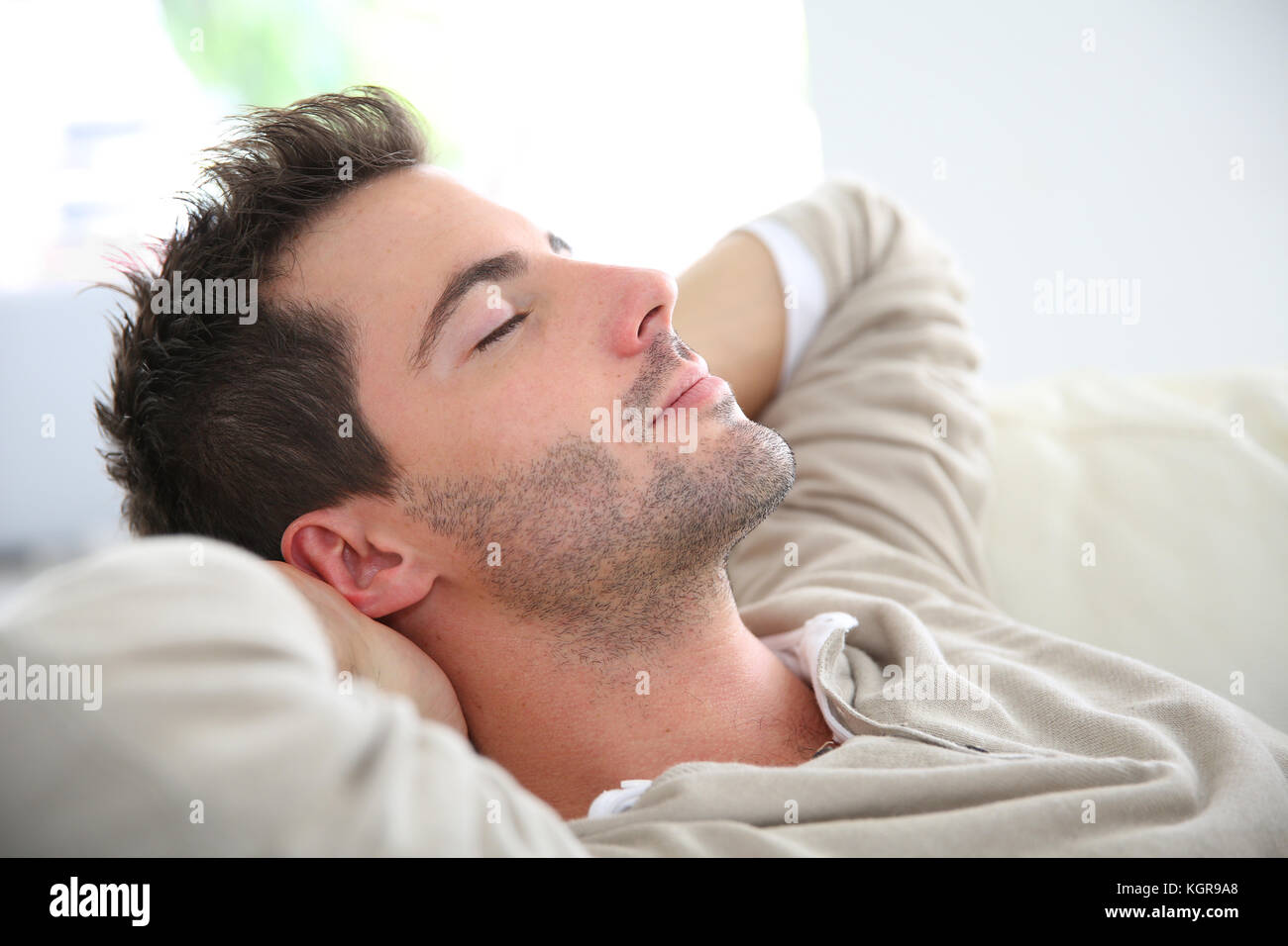 Man taking a nap in sofa Stock Photo Alamy