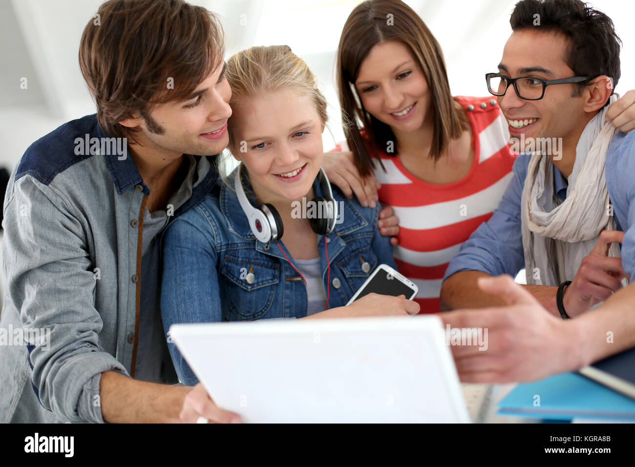 Group of teenagers using laptop at school Stock Photo