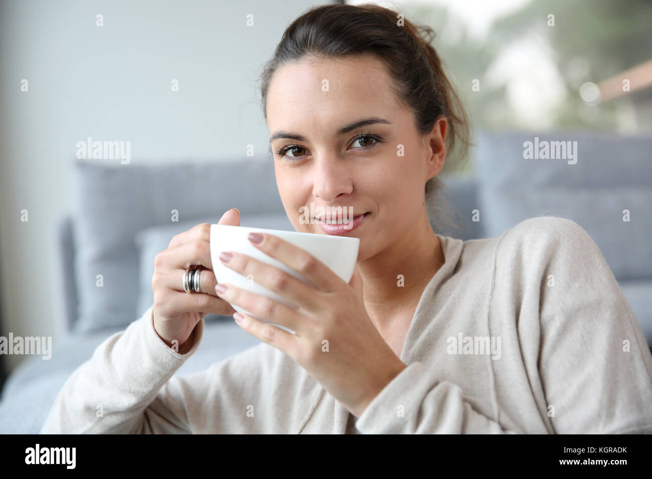 Peaceful woman relaxing at home with cup of tea Stock Photo - Alamy