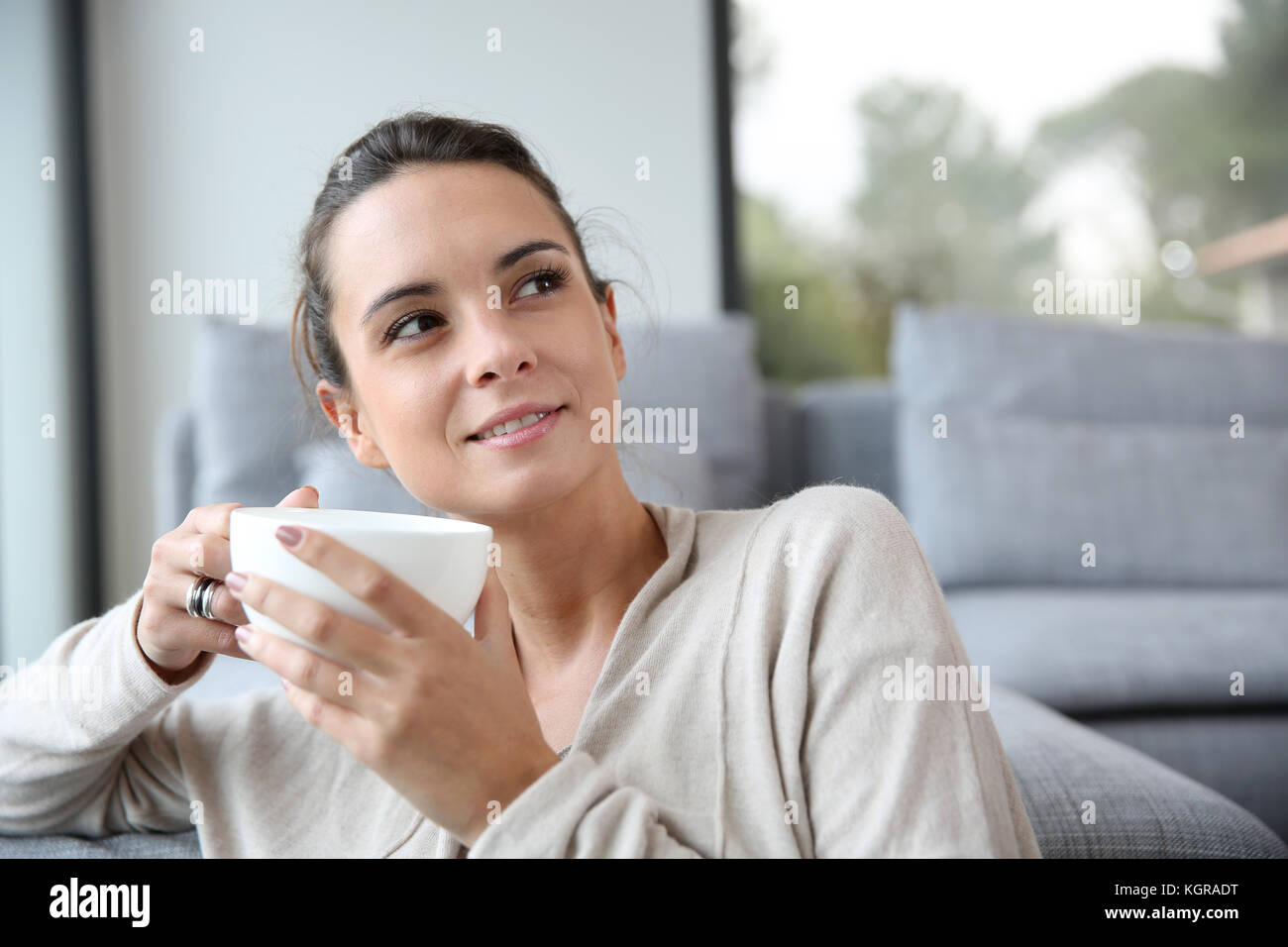 Peaceful woman relaxing at home with cup of tea Stock Photo - Alamy