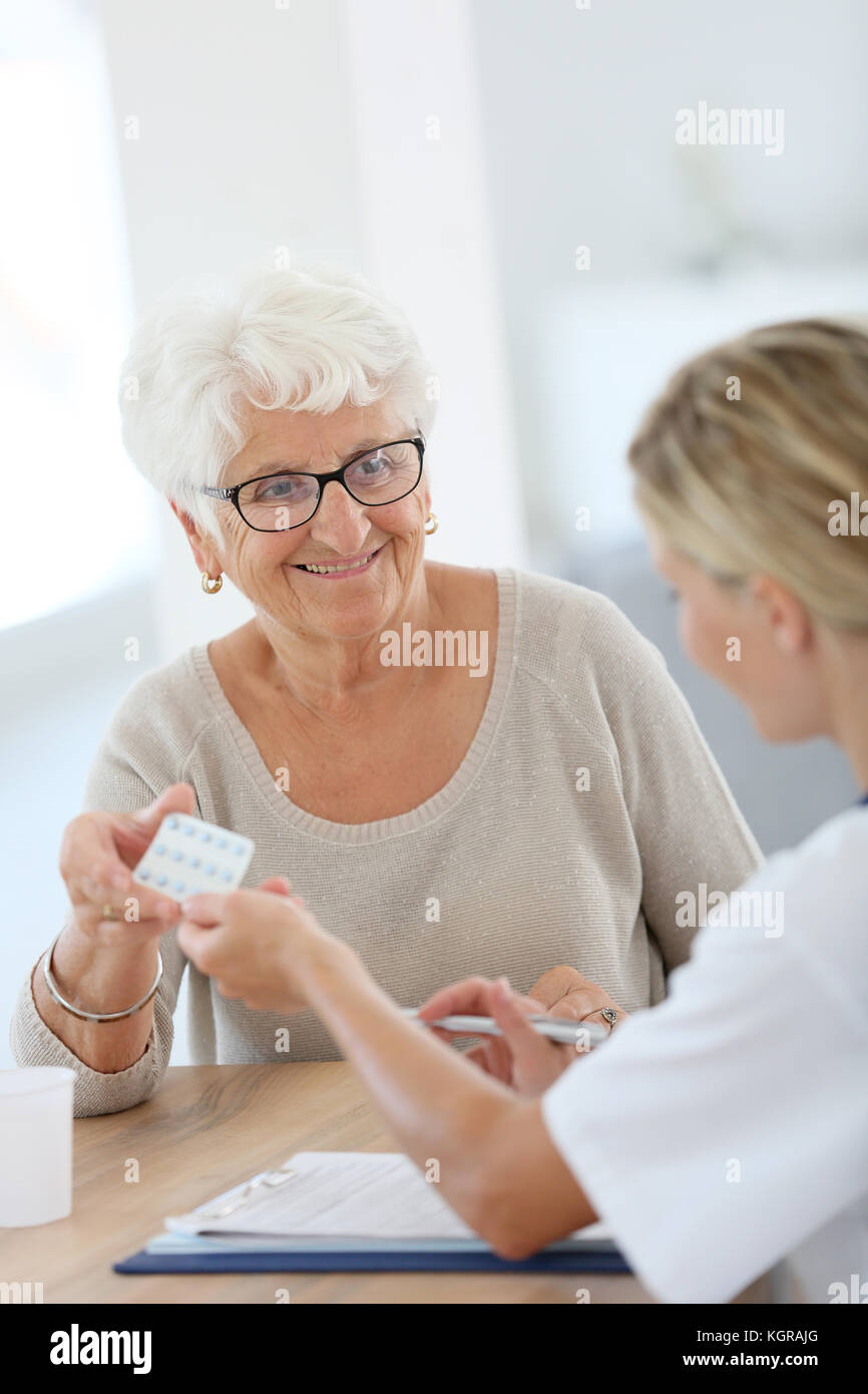 Doctor giving pills to elderly woman Stock Photo Alamy