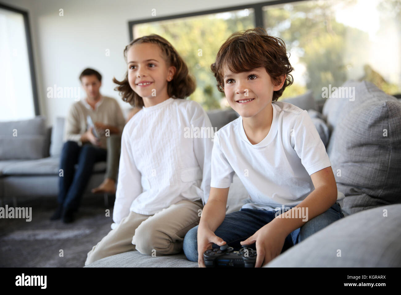 Kids at home playing video game Stock Photo
