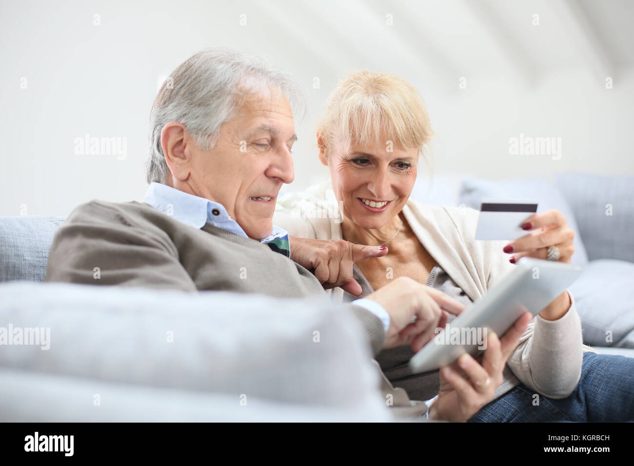 Senior couple e-shopping with digital tablet Stock Photo