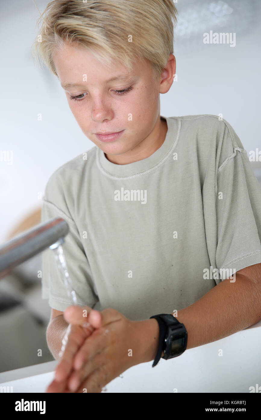 Young boy washing his hands Stock Photo