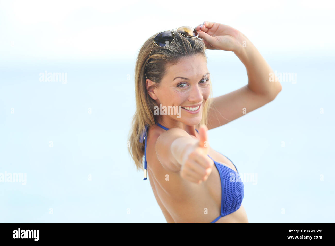 Beautiful woman in bikini showing thumbs up Stock Photo - Alamy