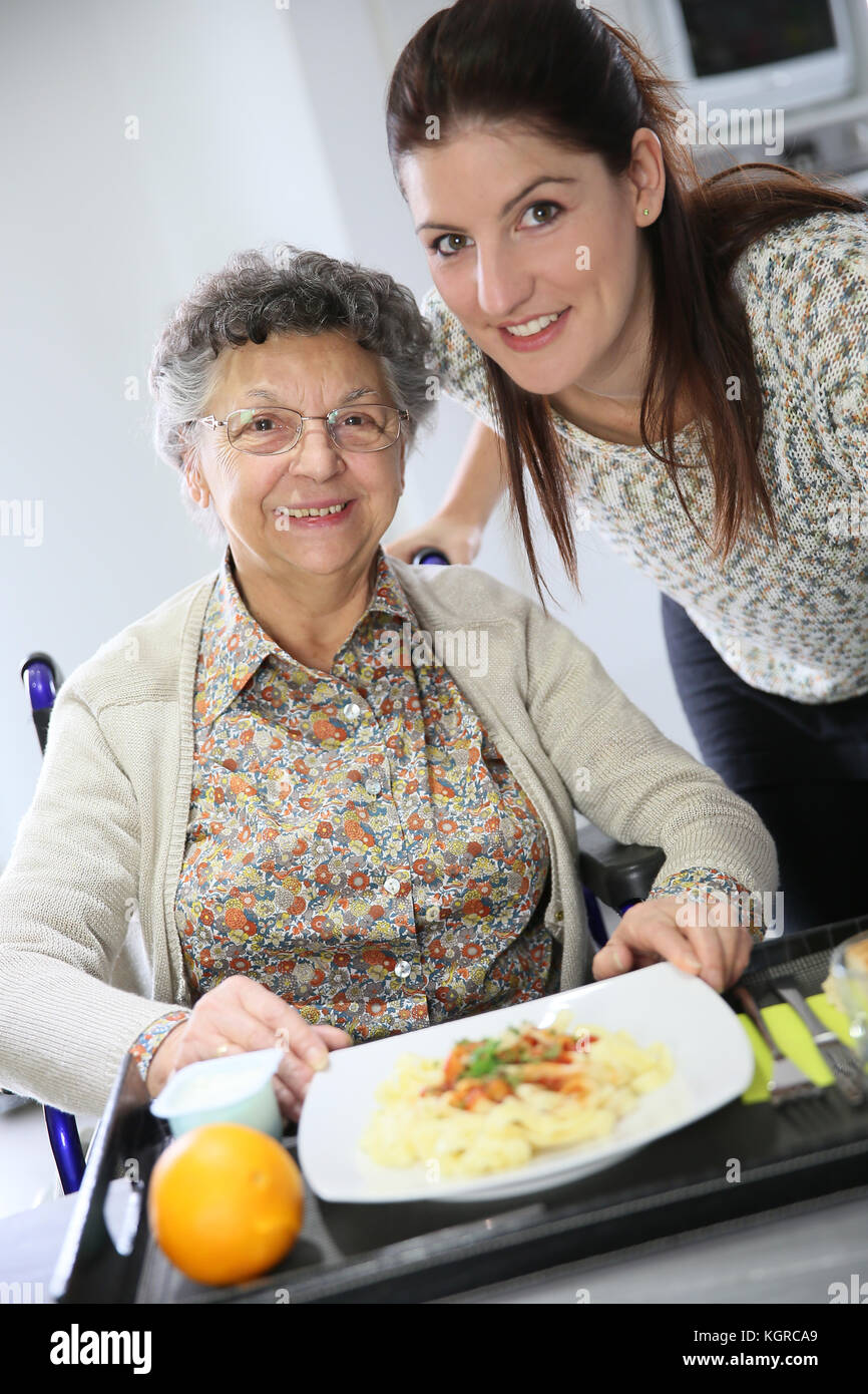 Homecarer preparing lunch for elderly woman Stock Photo Alamy