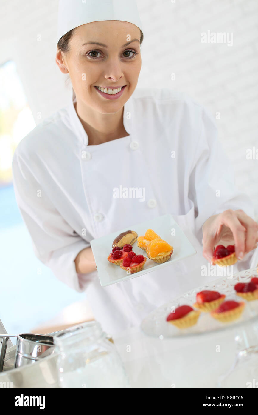 Pastrycook preparing plate of cake bites Stock Photo Alamy