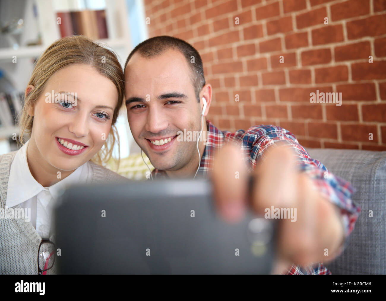 Friends taking picture of themselves with smartphone Stock Photo