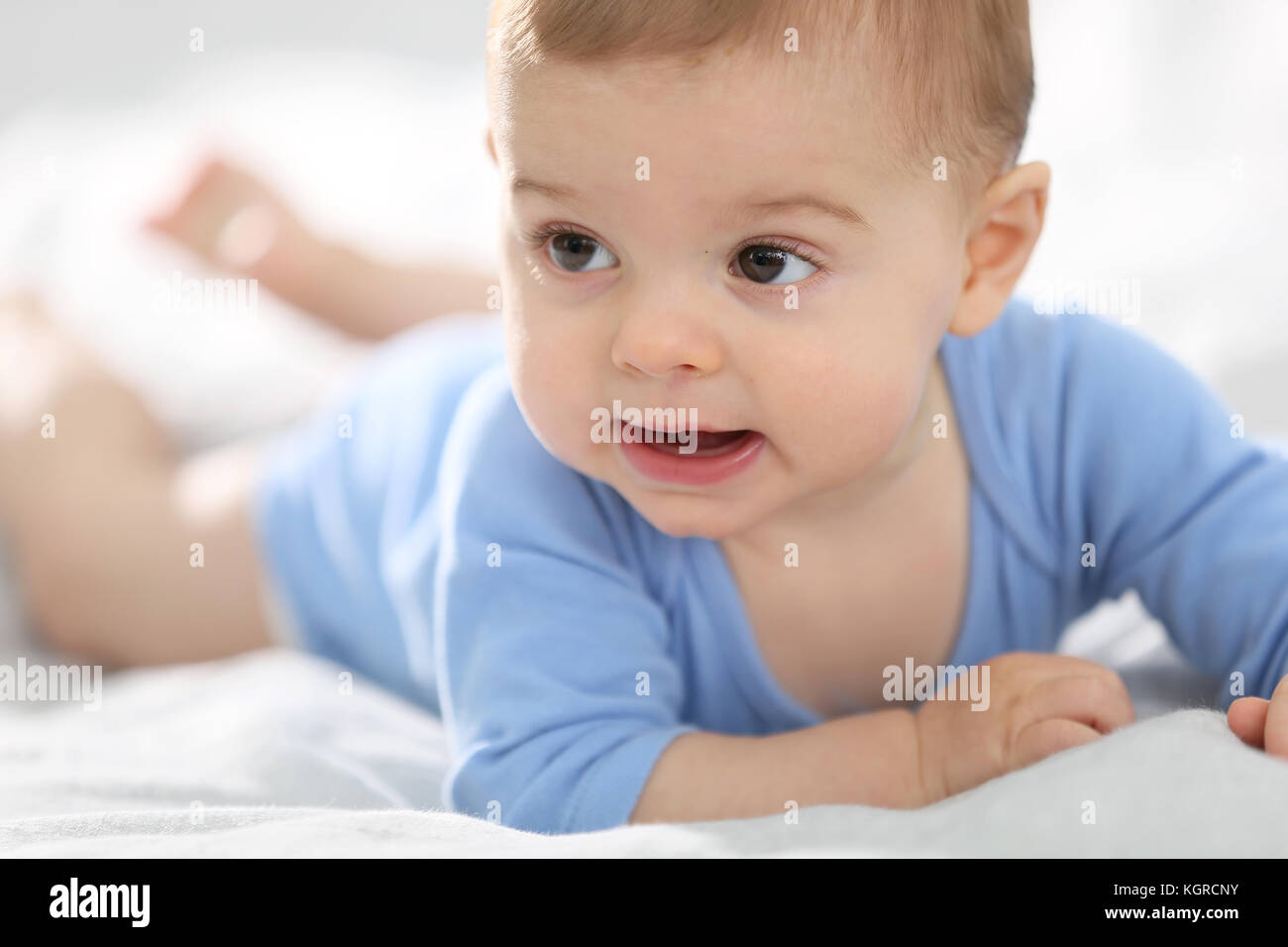 8monthold baby boy laying on bed Stock Photo Alamy