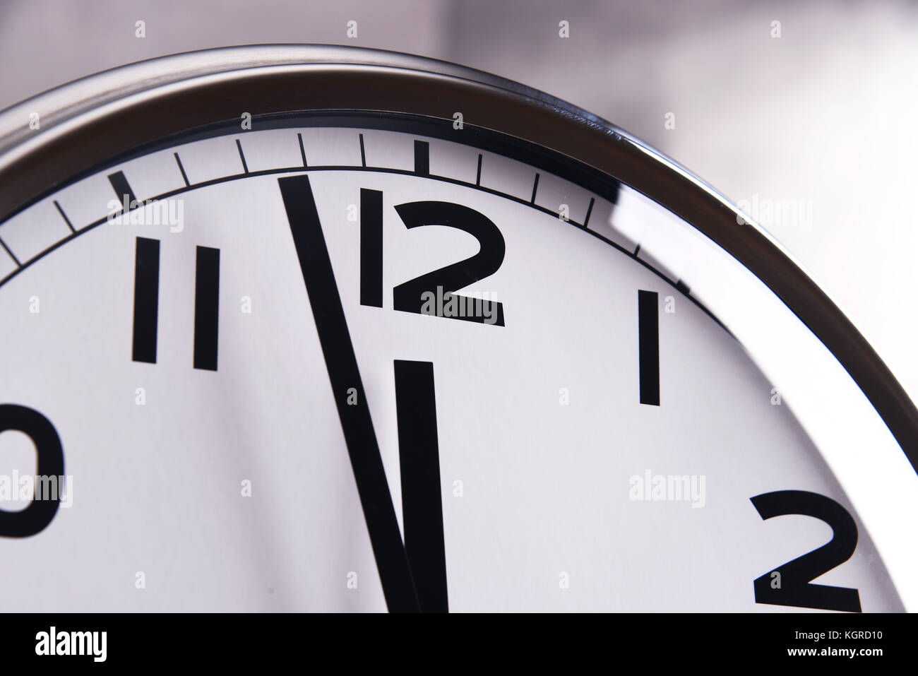 Wall clock showing five to twelve Stock Photo - Alamy