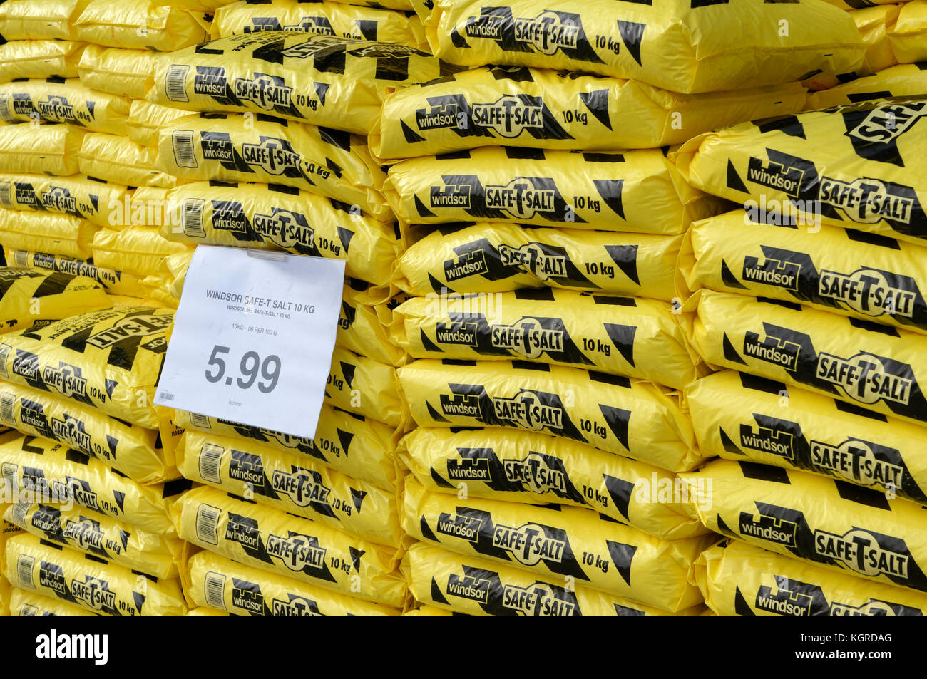 Closeup of yellow plastic bags of winter safety salt ice melt piled
