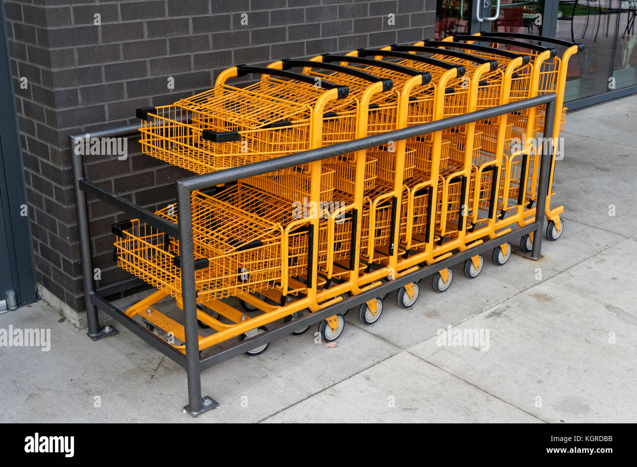 Orange metal wire shopping carts lined up outside a store in Vancouver