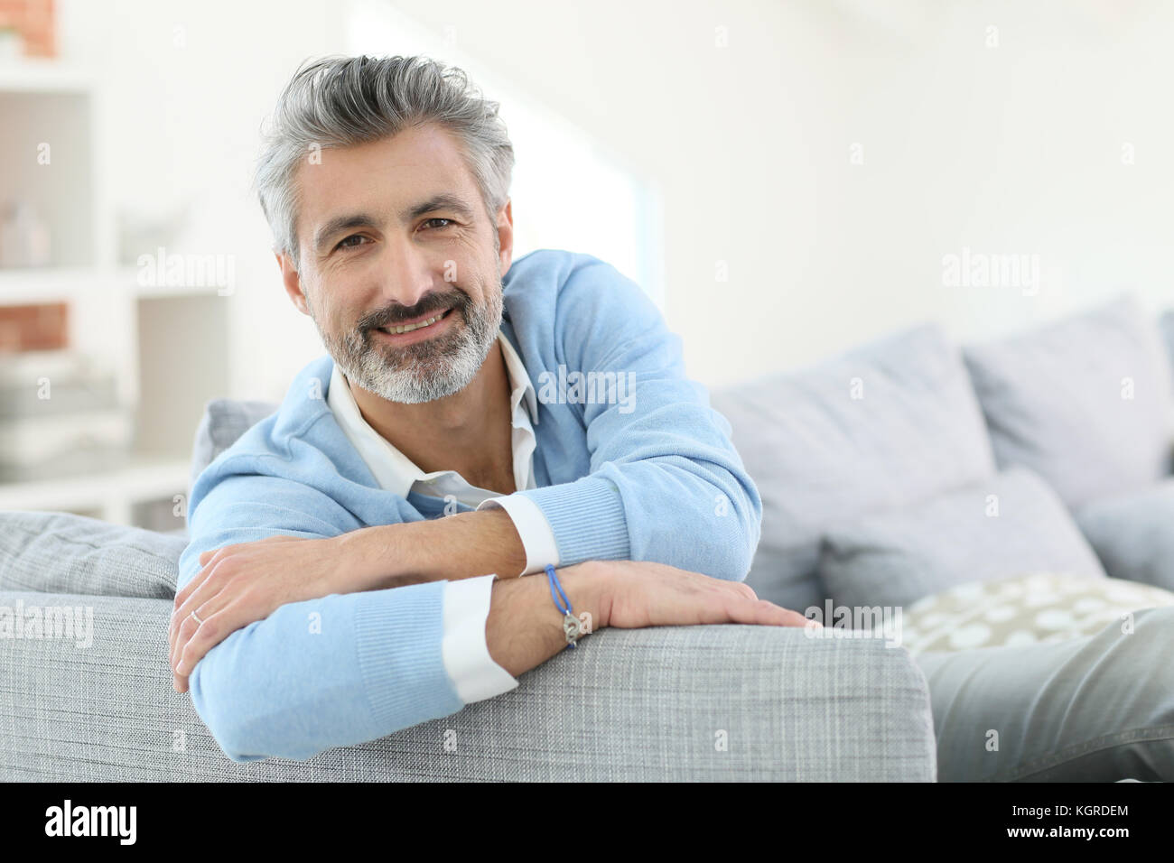 45-year-old man relaxing in sofa at home Stock Photo