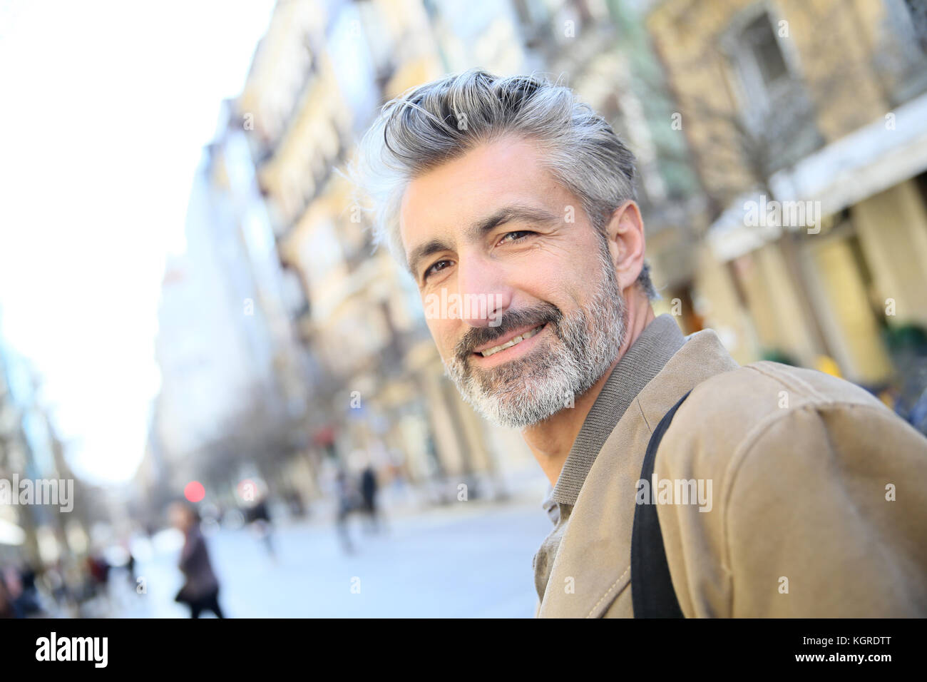 Handsome mature man walking in town Stock Photo