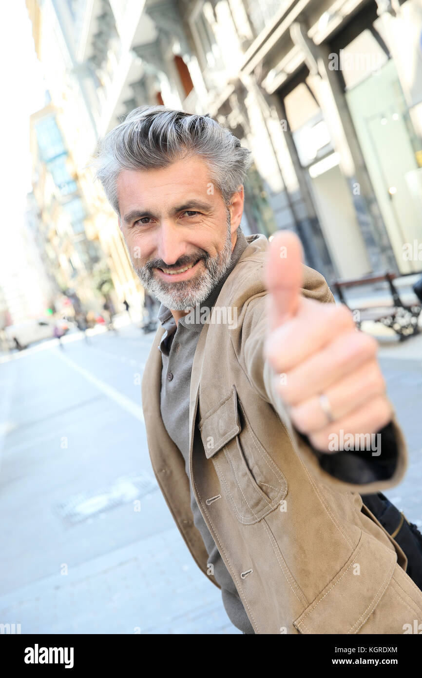 Handsome mature man showing thumb up Stock Photo