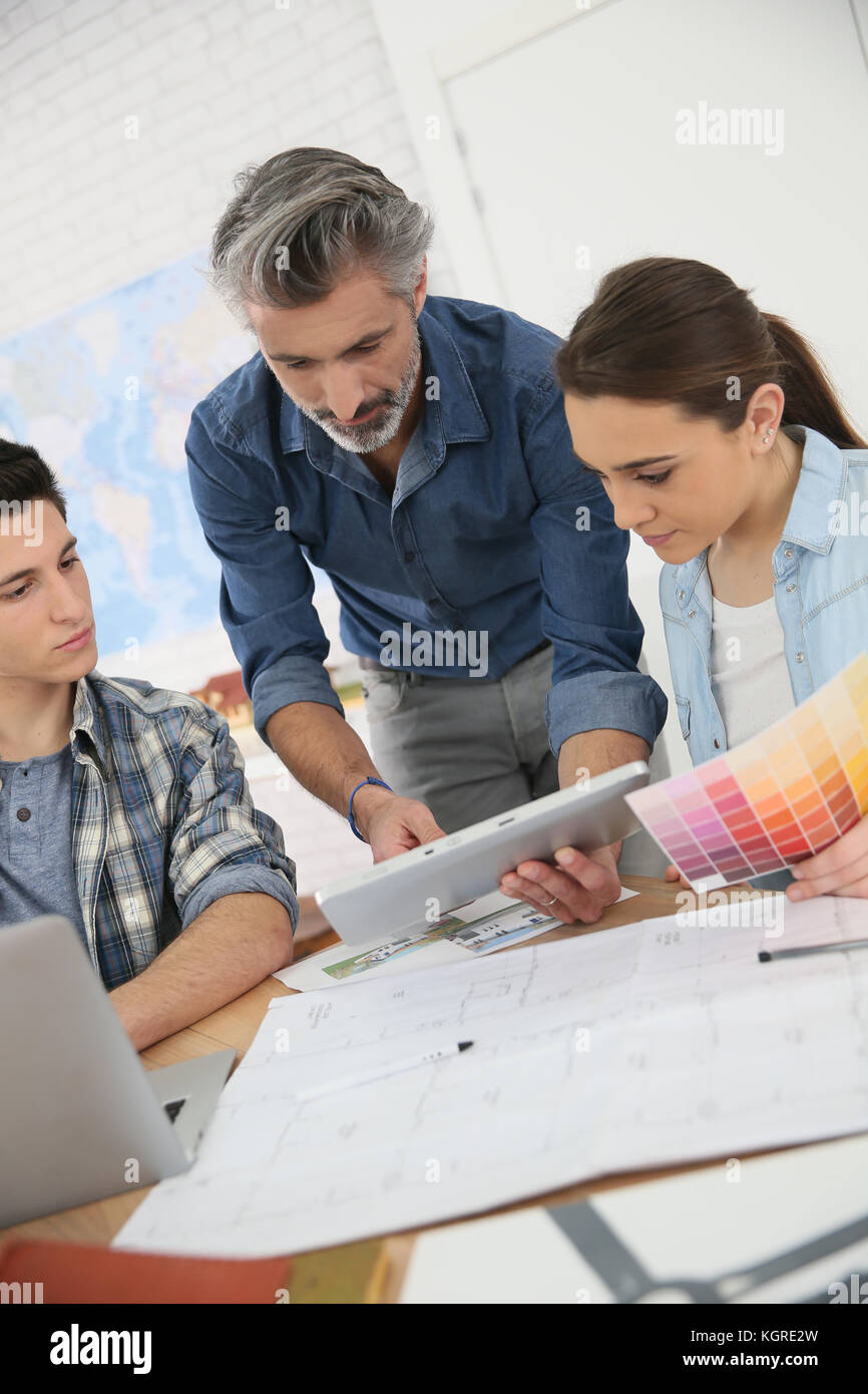 Teacher with students in architecture school Stock Photo - Alamy