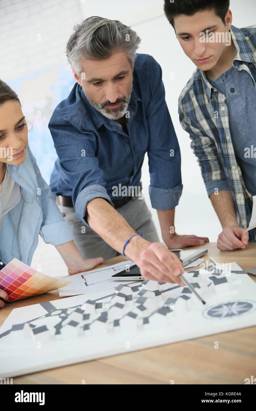 Students with trainer working on architecture project Stock Photo