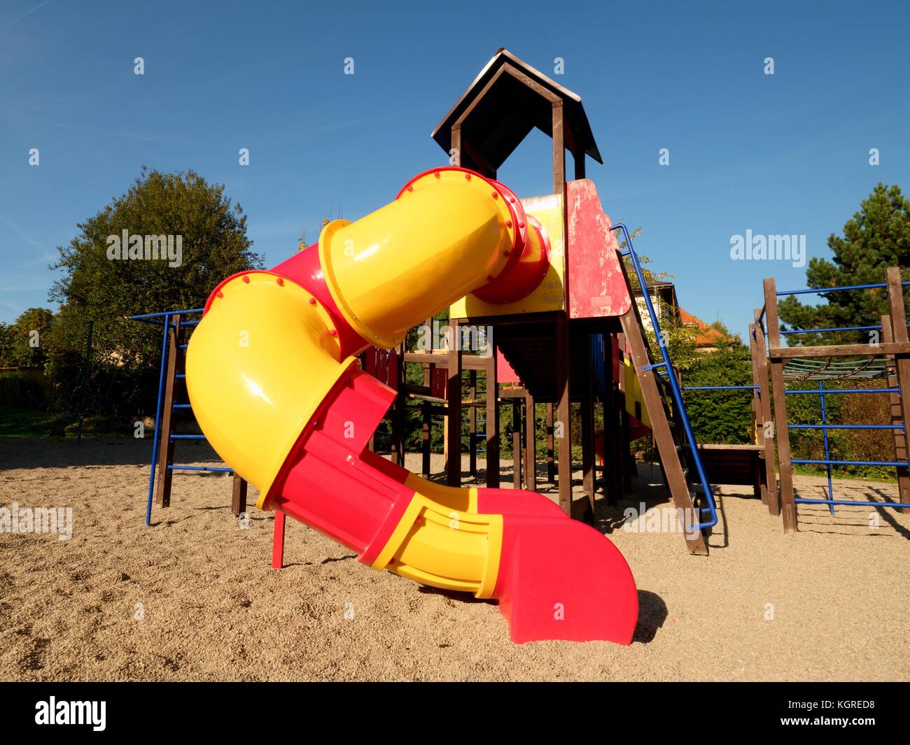 Playground colorful tube slide in public park. New plastic slider tube