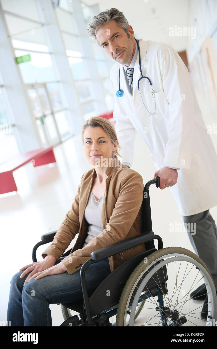 Doctor talking to woman in wheelchair after surgery Stock Photo Alamy