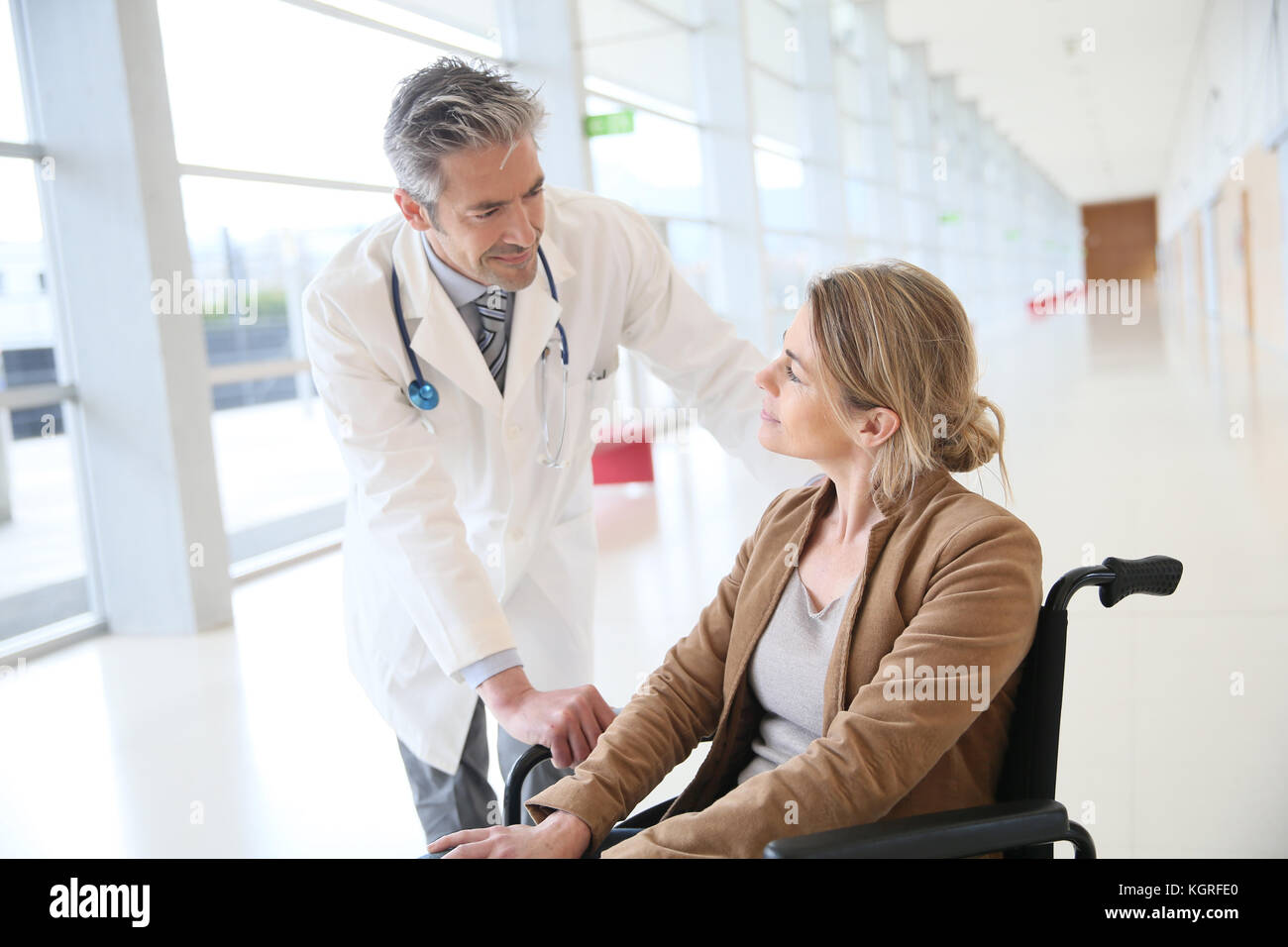 Doctor talking to woman in wheelchair after surgery Stock Photo Alamy
