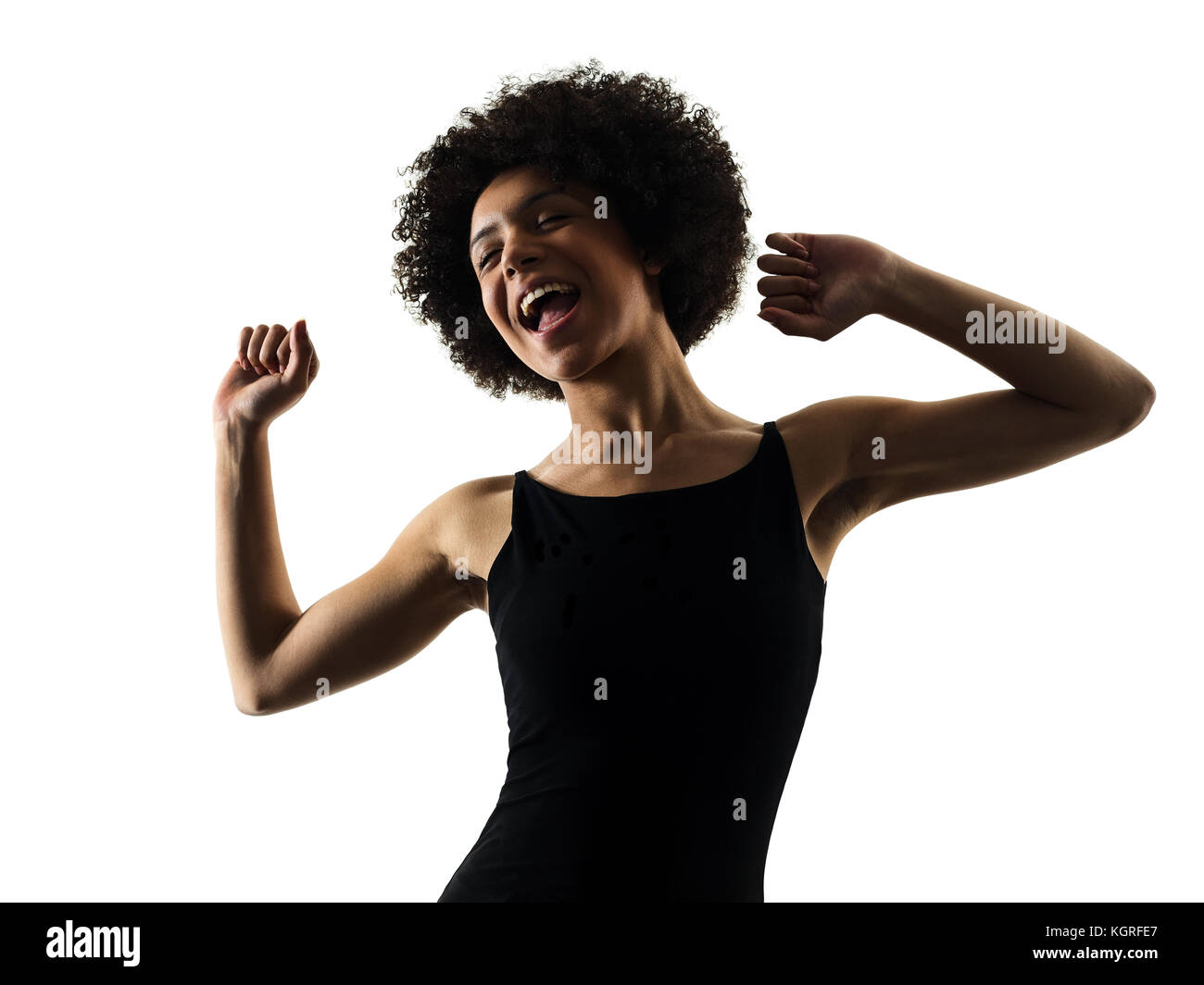 one mixed race african young teenager girl woman happy dancer dancing in studio shadow silhouette isolated on white background Stock Photo