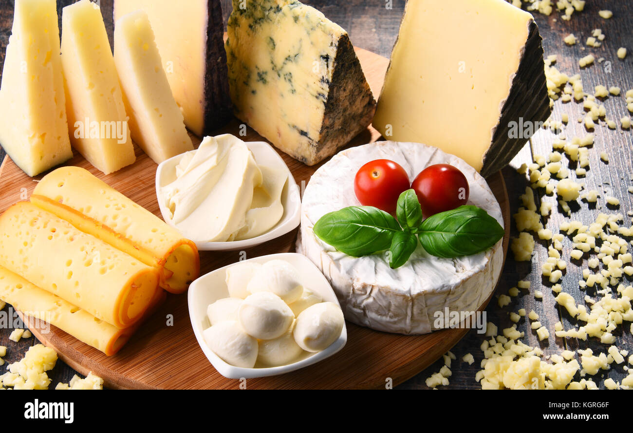 Different sorts of cheese on kitchen table Stock Photo - Alamy
