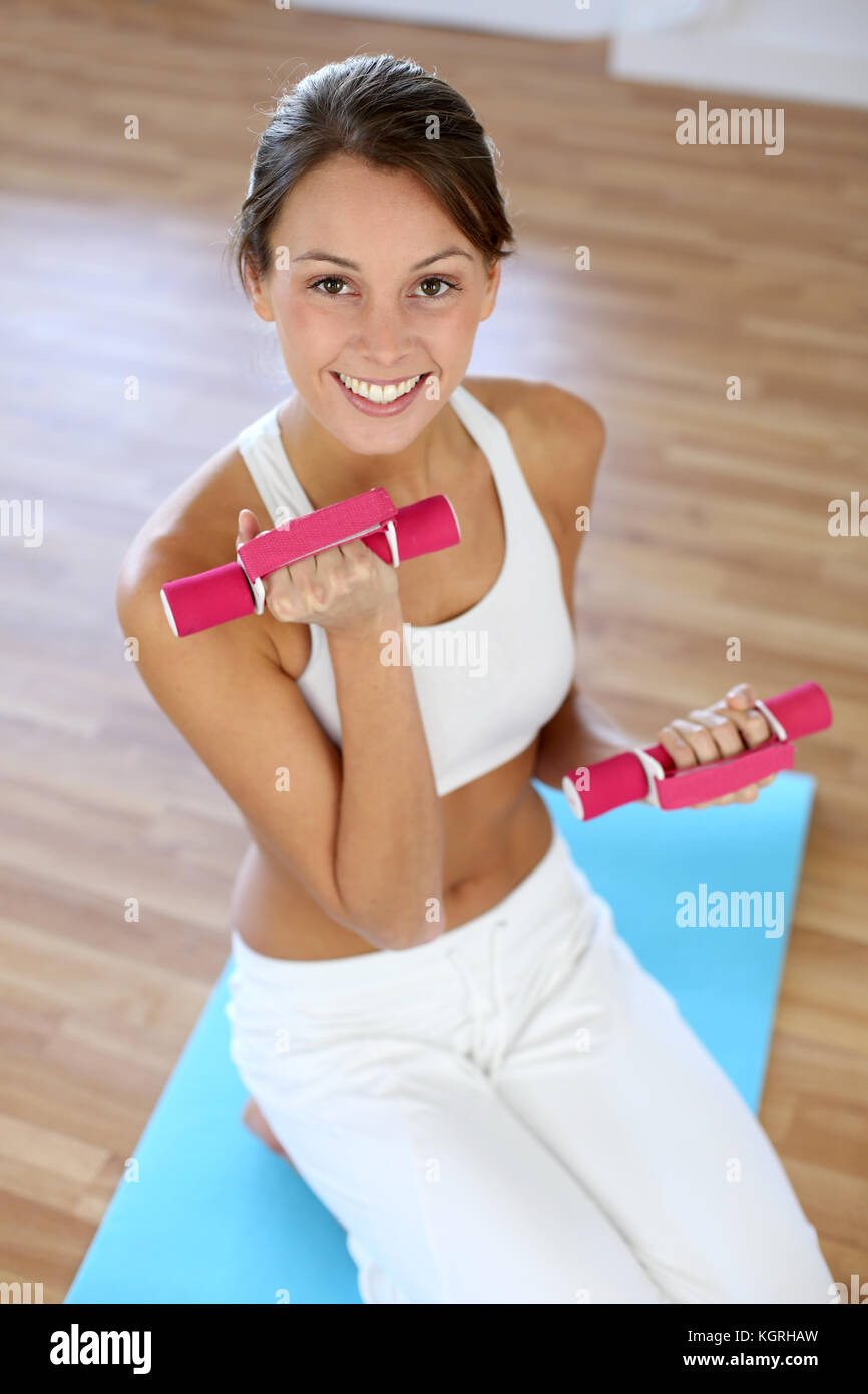 Fitness girl lifting dumbbells in gym Stock Photo Alamy
