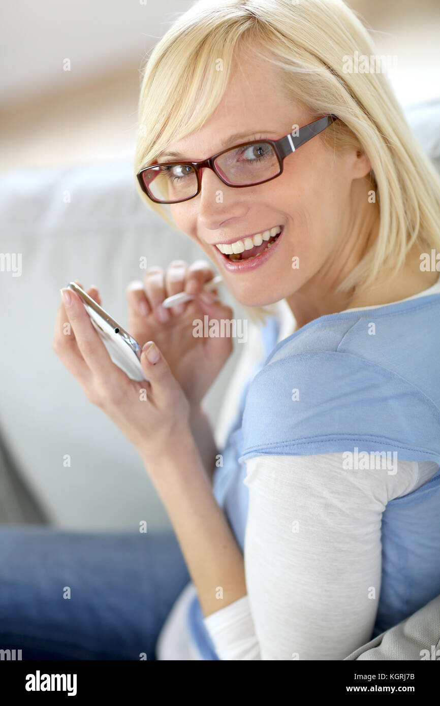 Blond girl sitting on sofa hi-res stock photography and images - Alamy