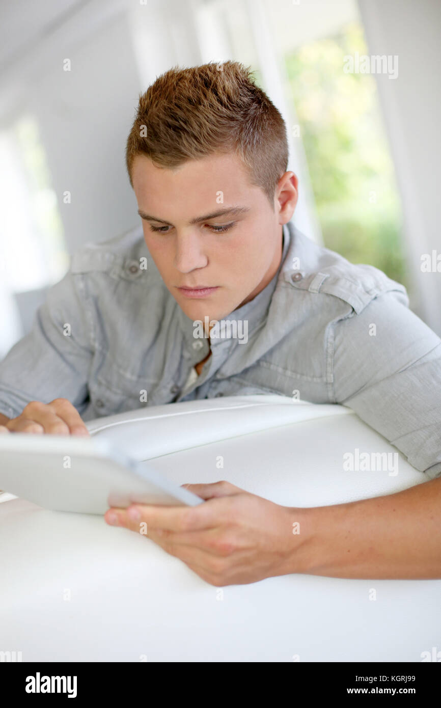 Young Man Using Electronic Tablet At Home Stock Photo Alamy young-man-using-electronic-tablet-at-home-stock-photo-alamy