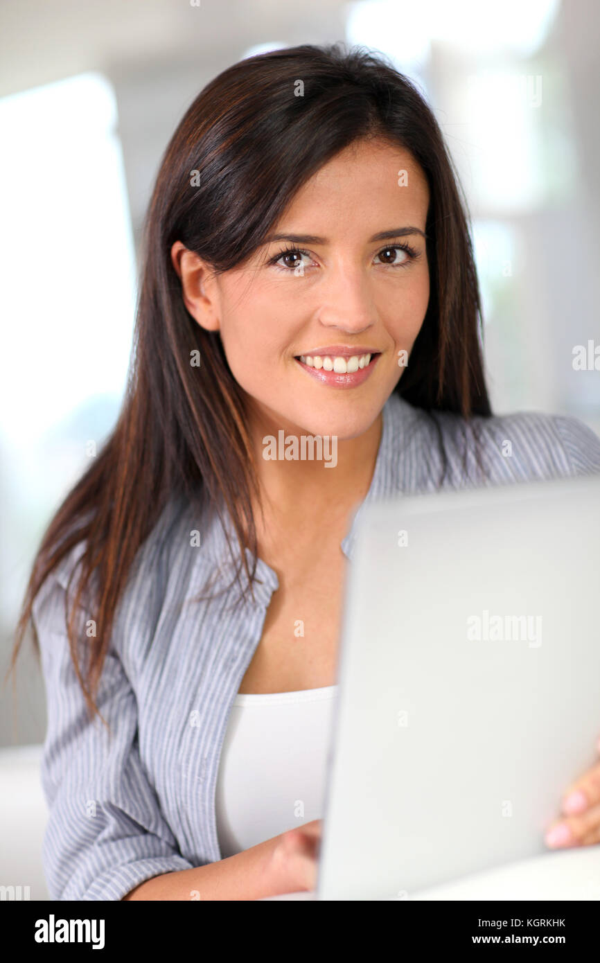 Young woman at home using electronic tablet Stock Photo - Alamy