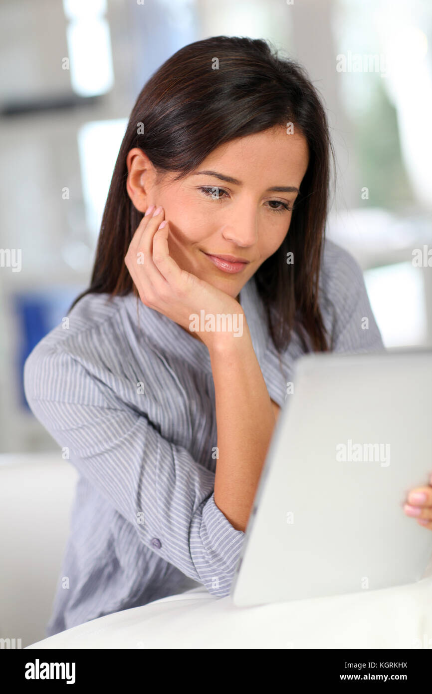 Young woman at home using electronic tablet Stock Photo - Alamy