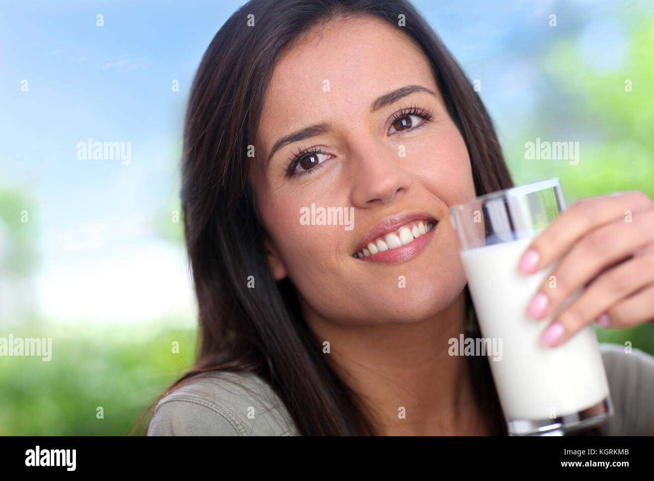 Young woman drinking glass of milk Stock Photo Alamy