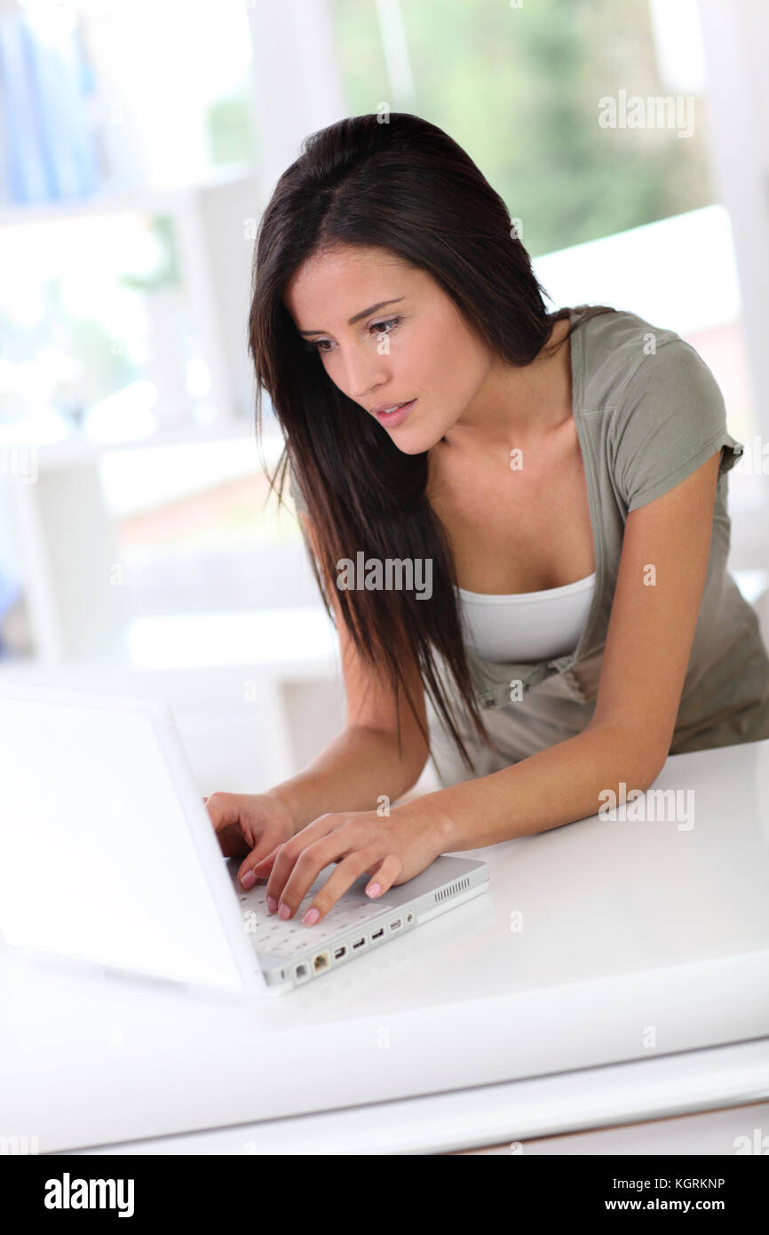Beautiful young woman working at home on laptop computer Stock Photo ...