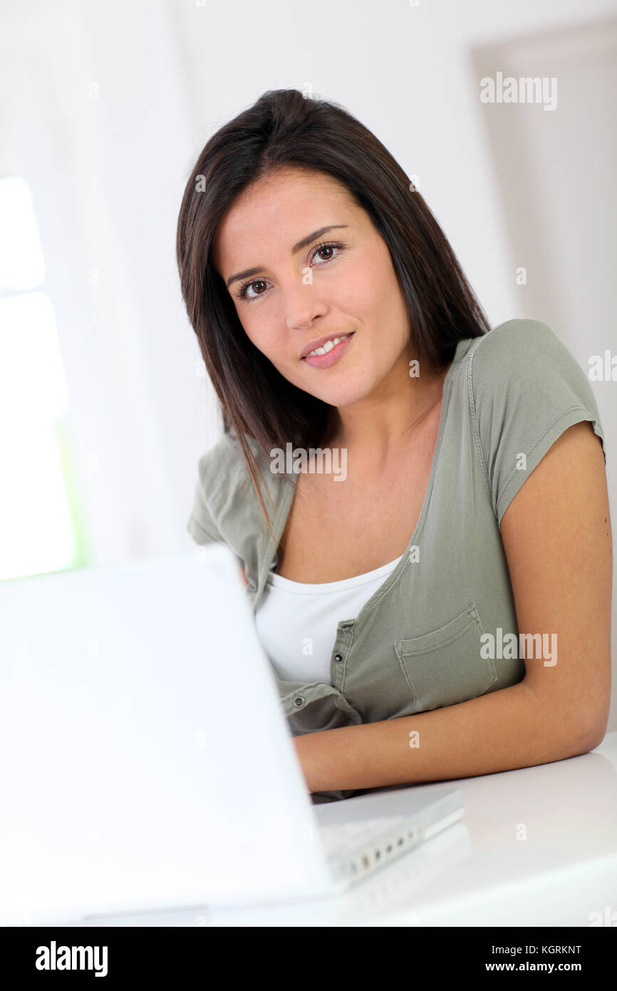Beautiful young woman working at home on laptop computer Stock Photo ...