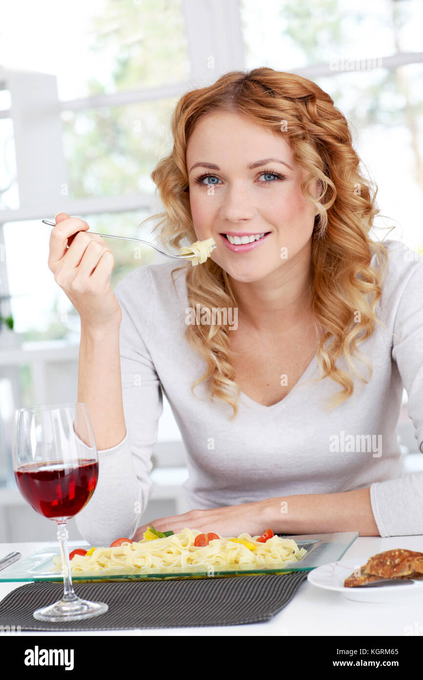 Woman eating pasta for dinner Stock Photo