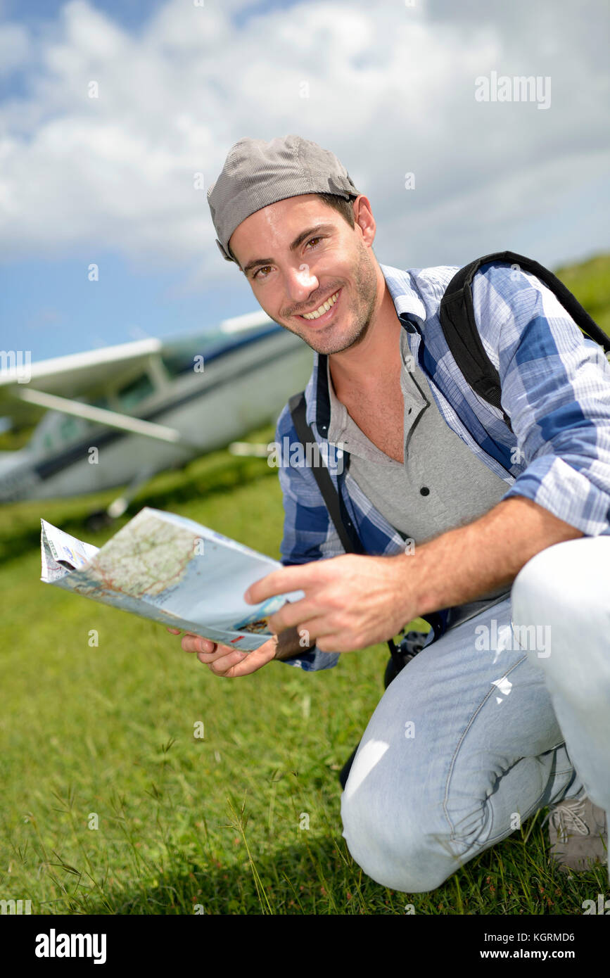 Adventurer looking at tourist map Stock Photo - Alamy