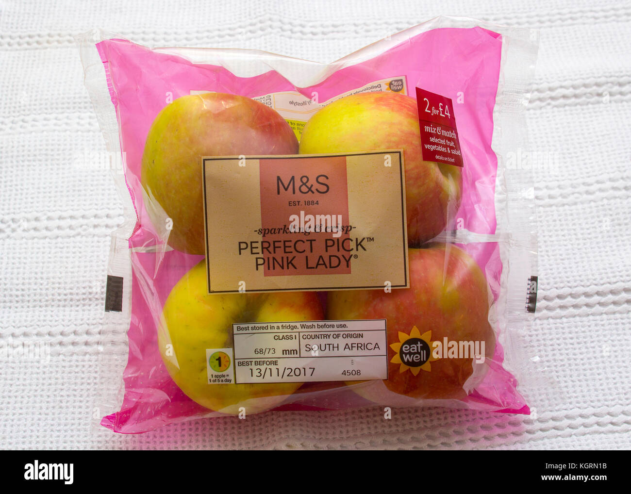 A four pack of Pink Lady eating apples with Marks and Spencer labelling