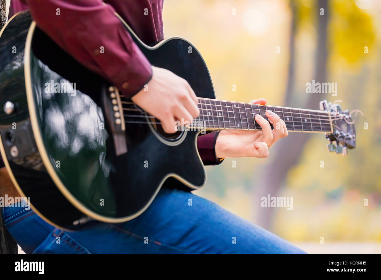 Close up person man's hands playing acoustic guitar artist musician. Focus on fingers. Stock Photo