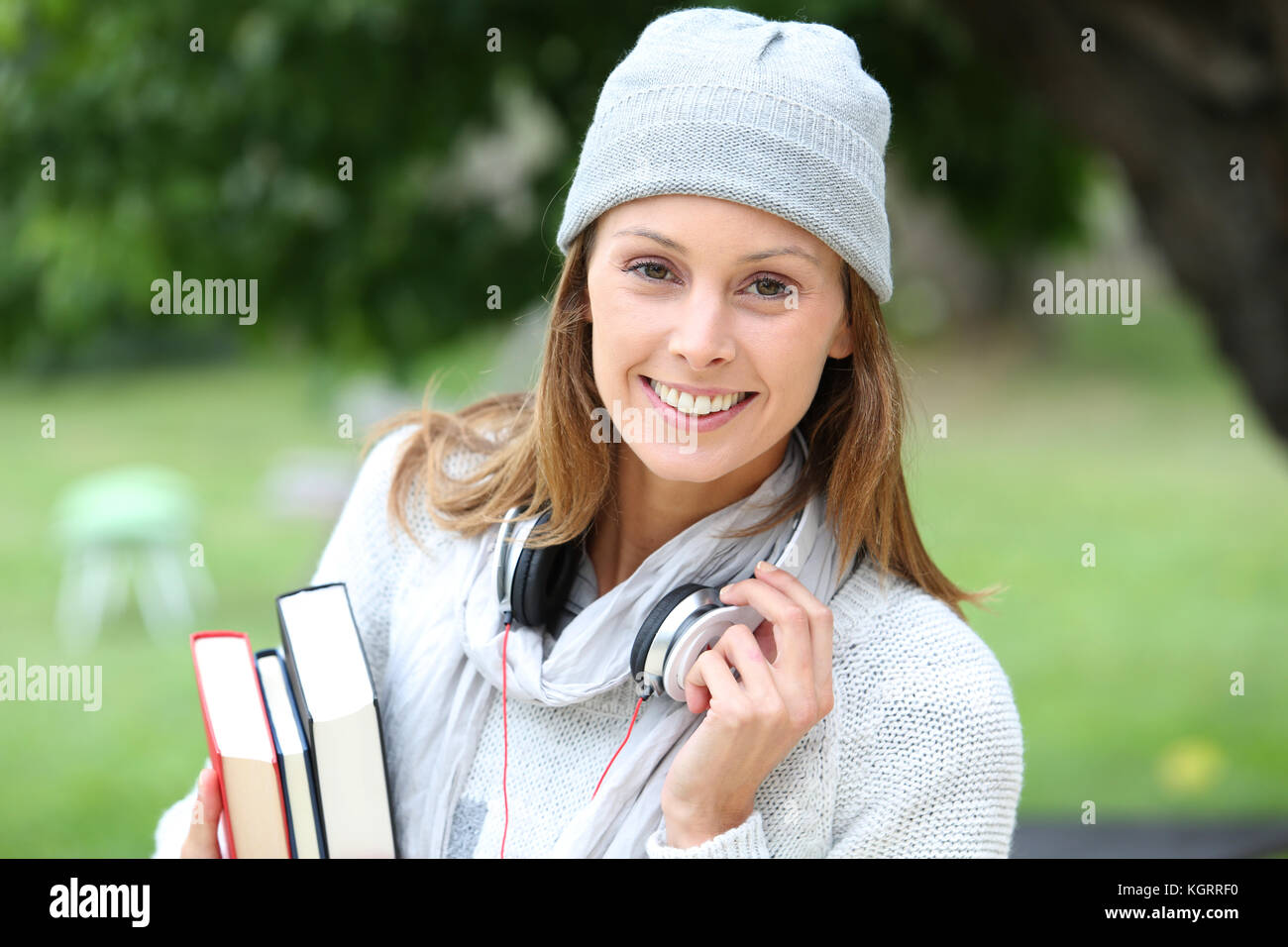College student standing in park Stock Photo - Alamy